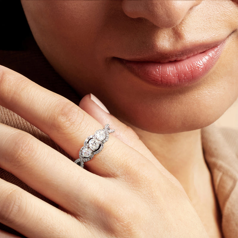 Diamond ring on hand, 14kt white gold band with haloed center stone