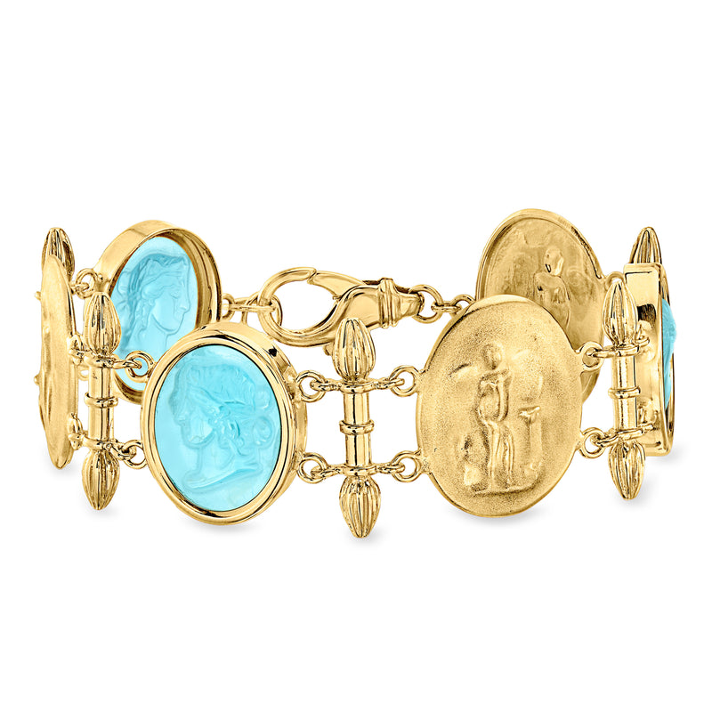 Gold-tone bracelet with blue oval glass stations and antique-style medallion links