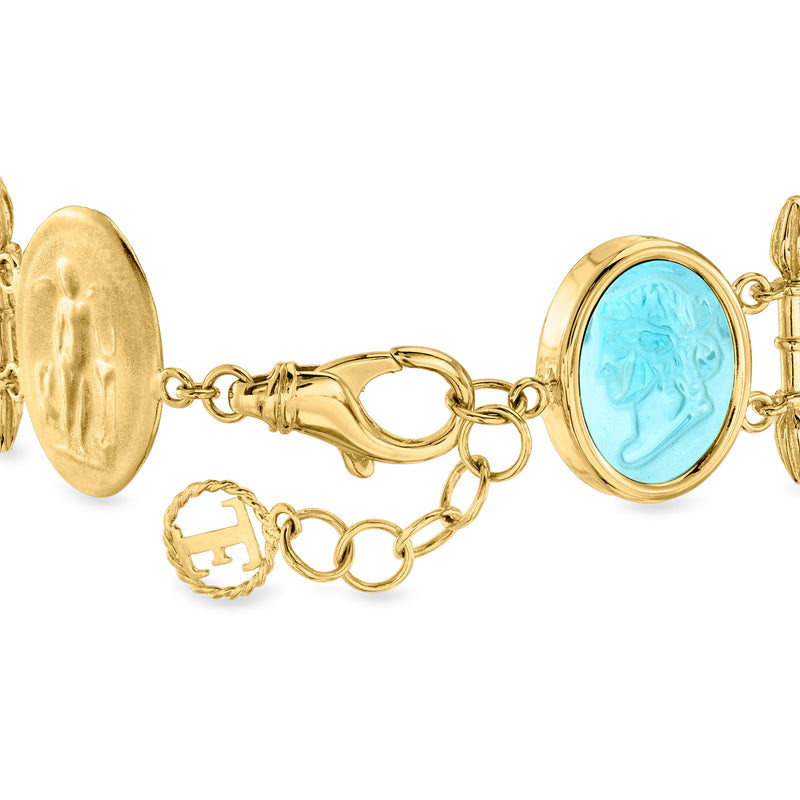 Gold-tone bracelet close-up with blue oval glass stations, chain links, and clasp