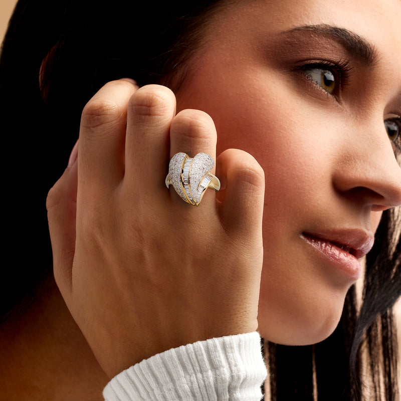Diamond heart ring in yellow gold on a model's hand