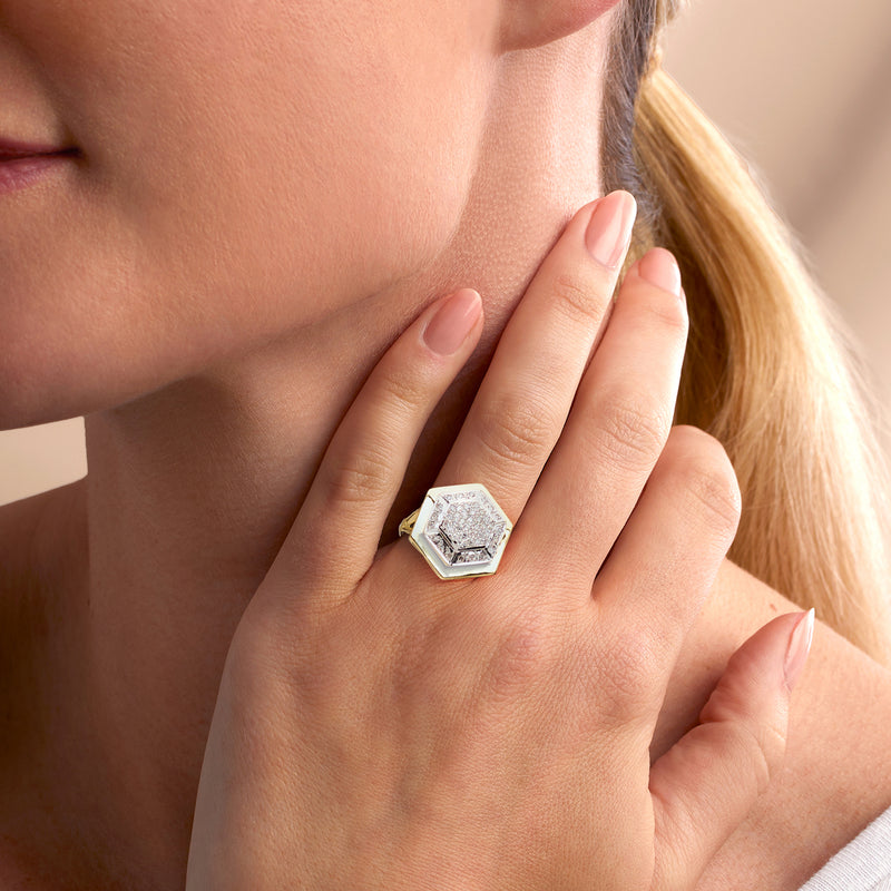 Geometric diamond cluster ring on hand with 18kt yellow gold square setting