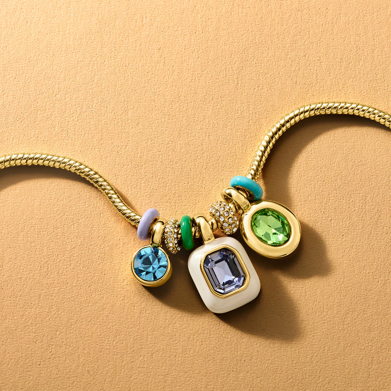 Yellow gold-plated charm necklace with blue, green, and gold enamel round and square charms