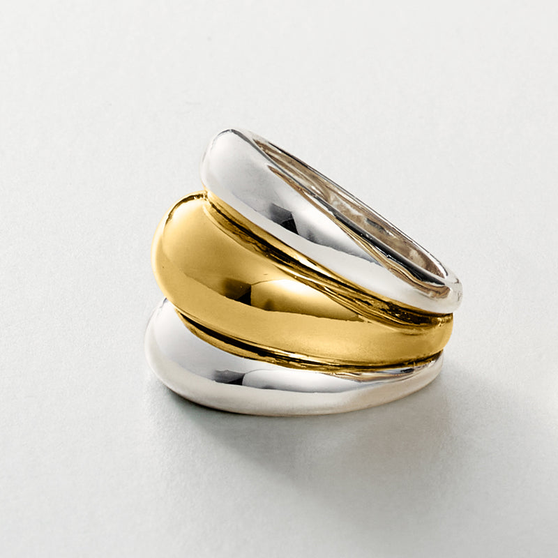 Stacked three-row silver and gold-plated ring, angled close-up view