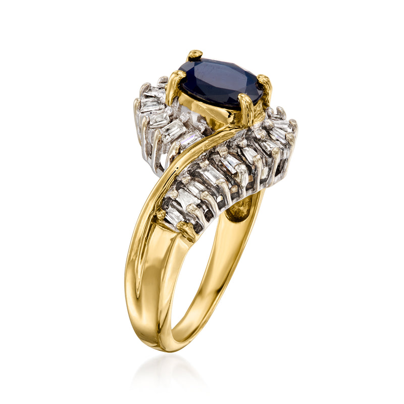 Yellow gold vintage ring showing blue sapphire center with baguette diamond swirls