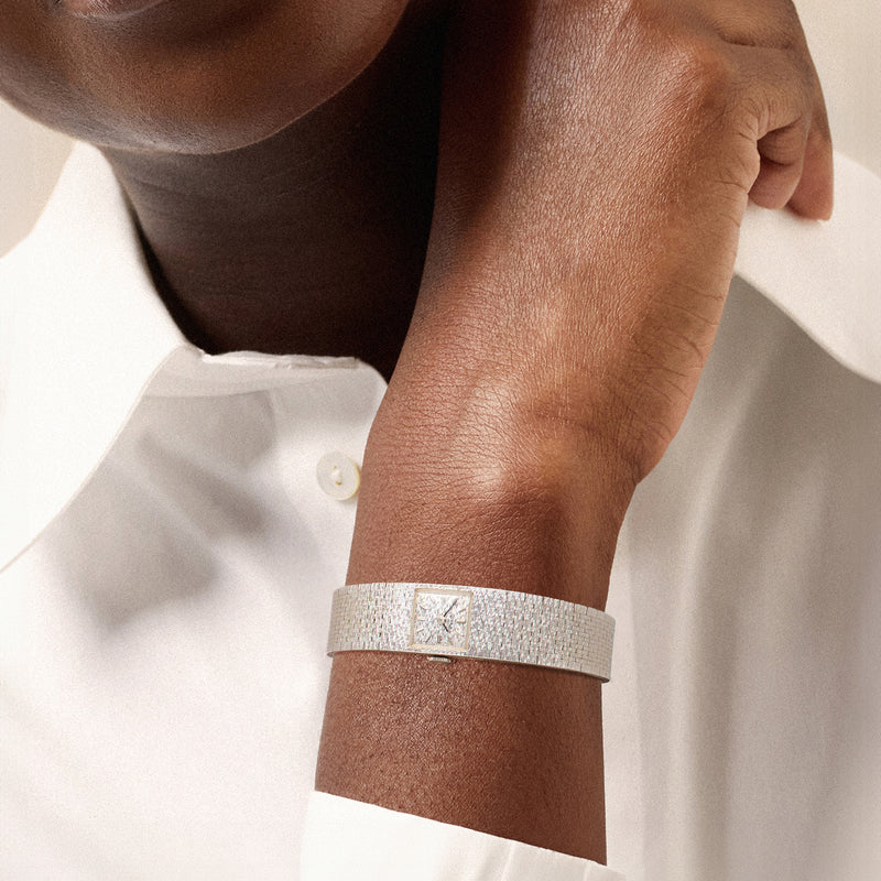 Juvenia white gold mesh watch bracelet on wrist, square dial