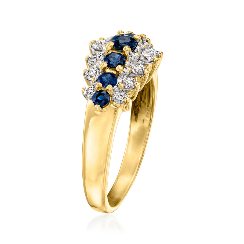 Yellow gold ring showing side view of blue sapphire cluster with round diamond accents