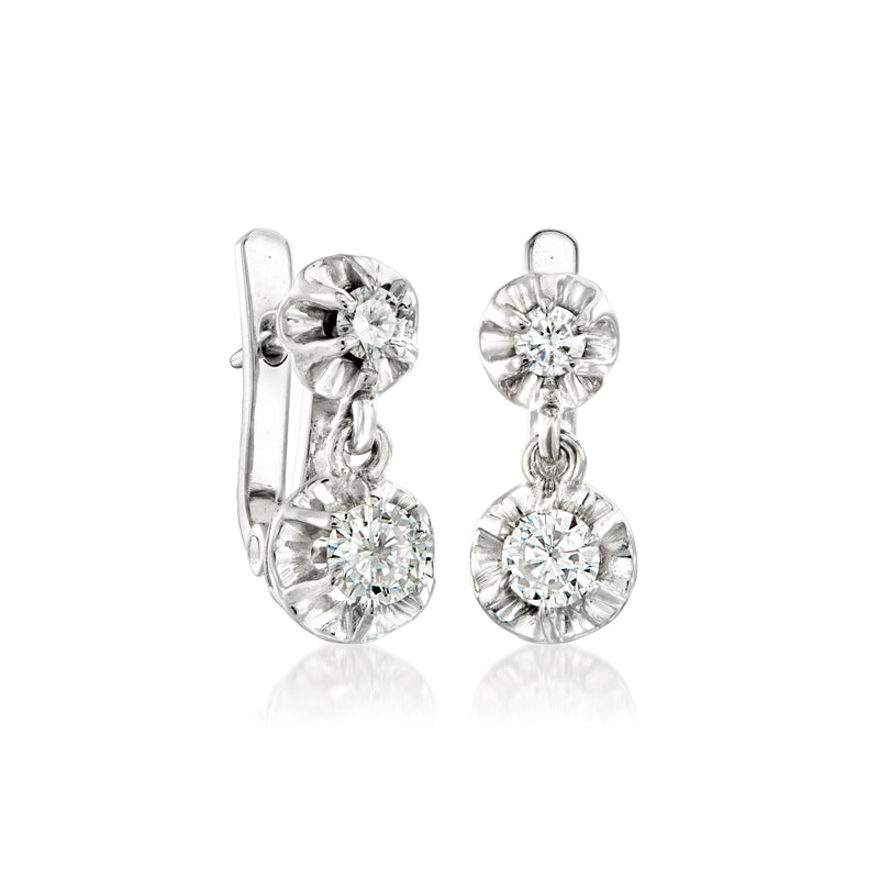 White gold diamond drop earrings, shown from side, with round stones and linked dangles.