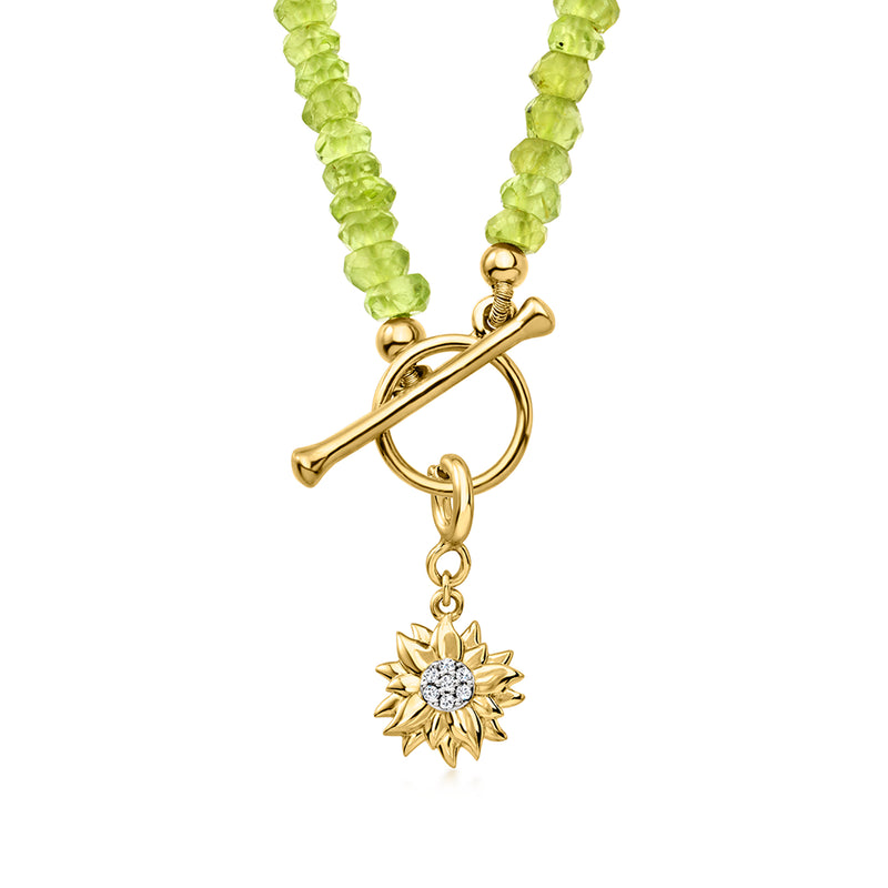 Gold sunflower charm pendant with round diamond center on a green beaded necklace