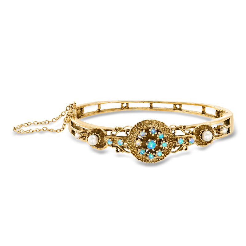 14kt yellow gold bangle bracelet with cultured pearls and blue opal-like center