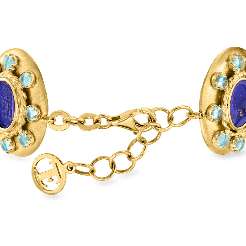 Gold-tone link bracelet with two blue oval glass end charms and light blue accents