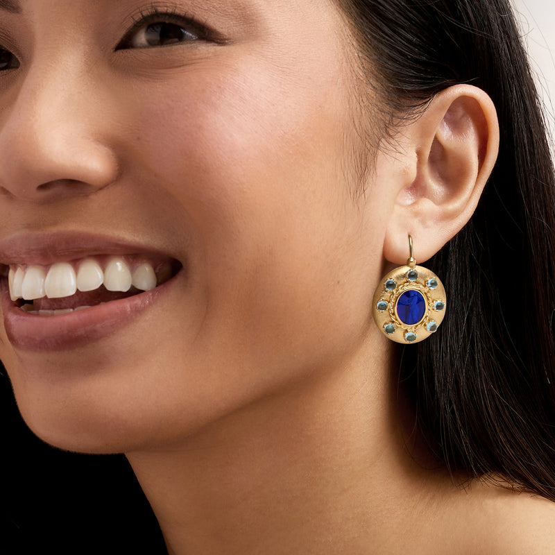 Gold-tone round blue drop earrings with blue glass center and light blue stone halo