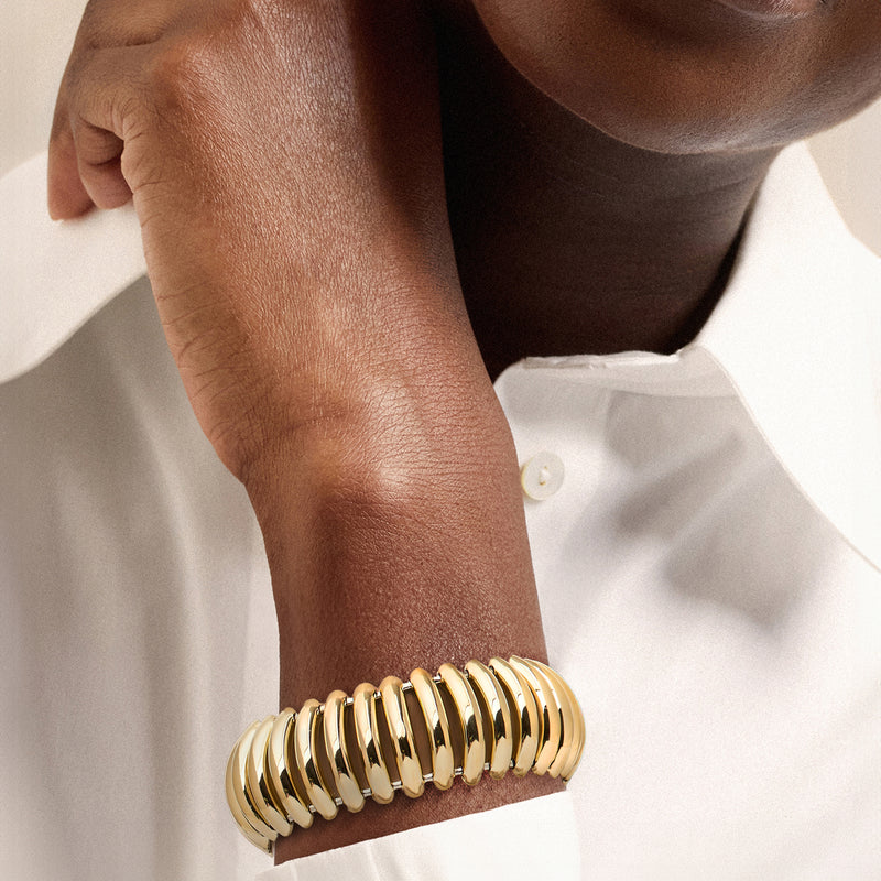 Two-tone gold ridged bracelet on wrist with alternating gold and silvertone oval links