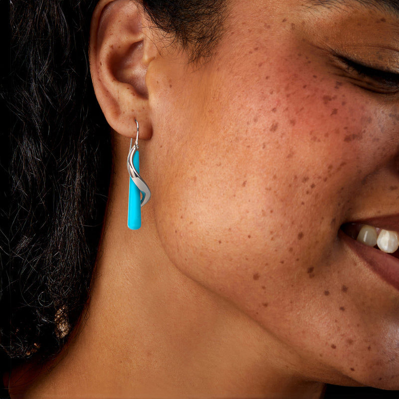 Sterling silver turquoise drop earrings on ear, spiral curve with long bar