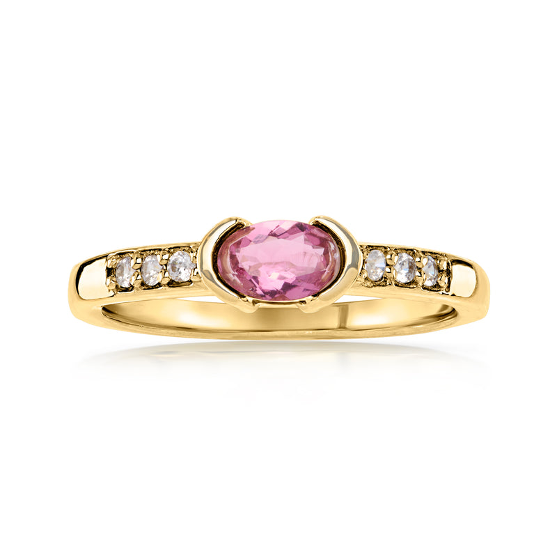 Gold oval pink tourmaline ring with small white zircon accents along the band