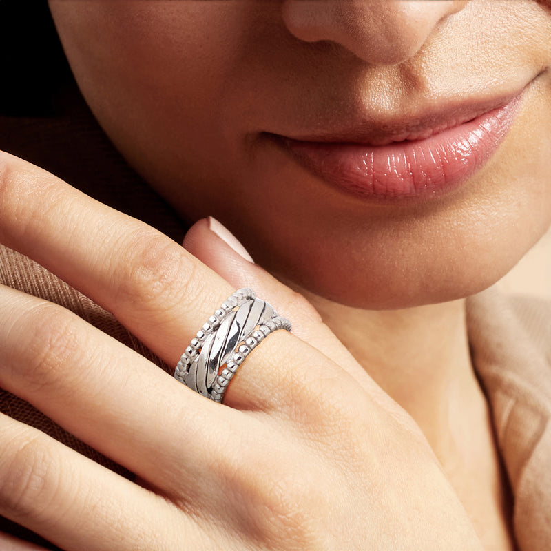 Rhodium-plated beaded border ring on finger, silver wave ridges with beaded edge