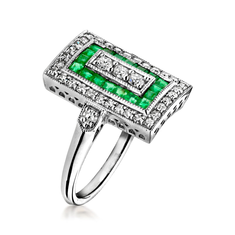 Platinum square ring with green emerald center and diamond details on top and sides