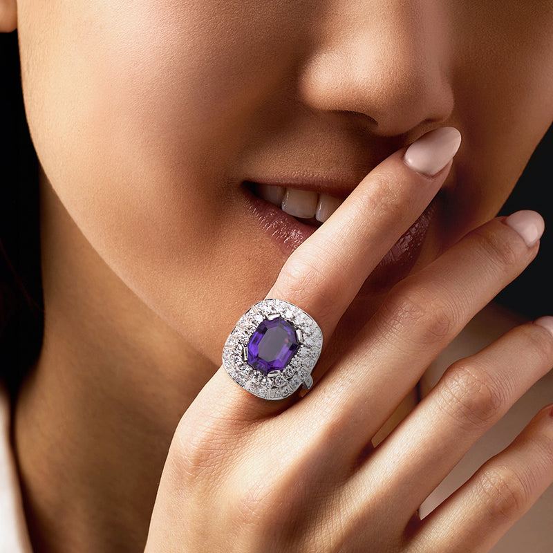 Amethyst ring with diamond halo on hand, oval purple center stone