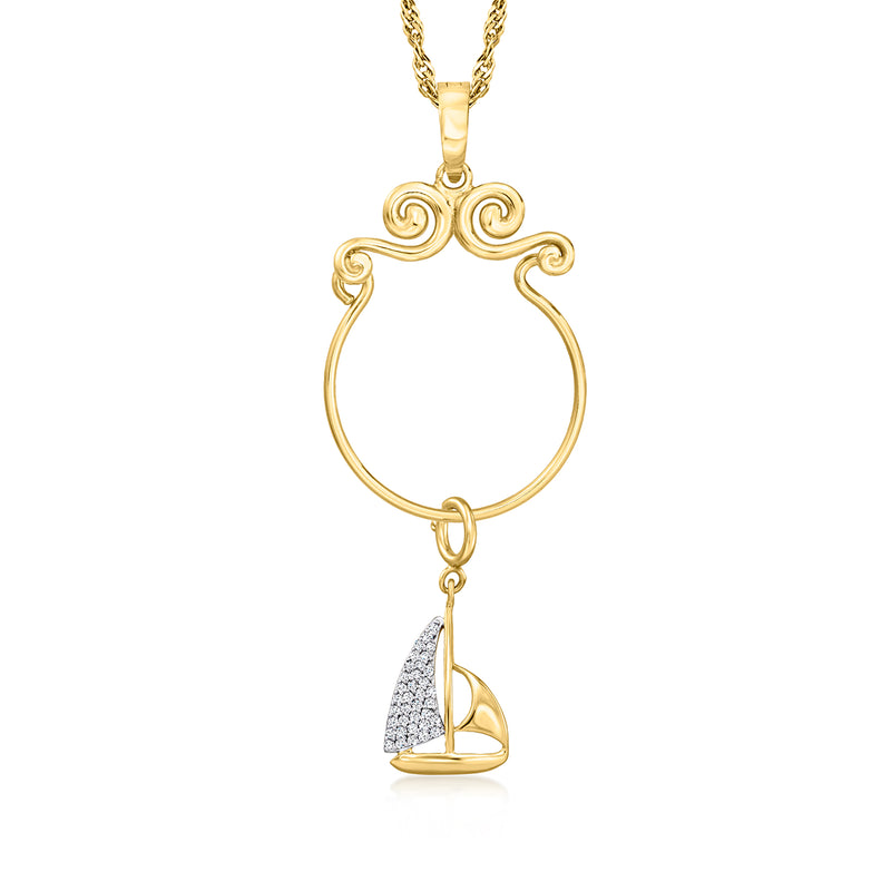 Gold sailboat charm pendant with glittered sail, hanging from a chain