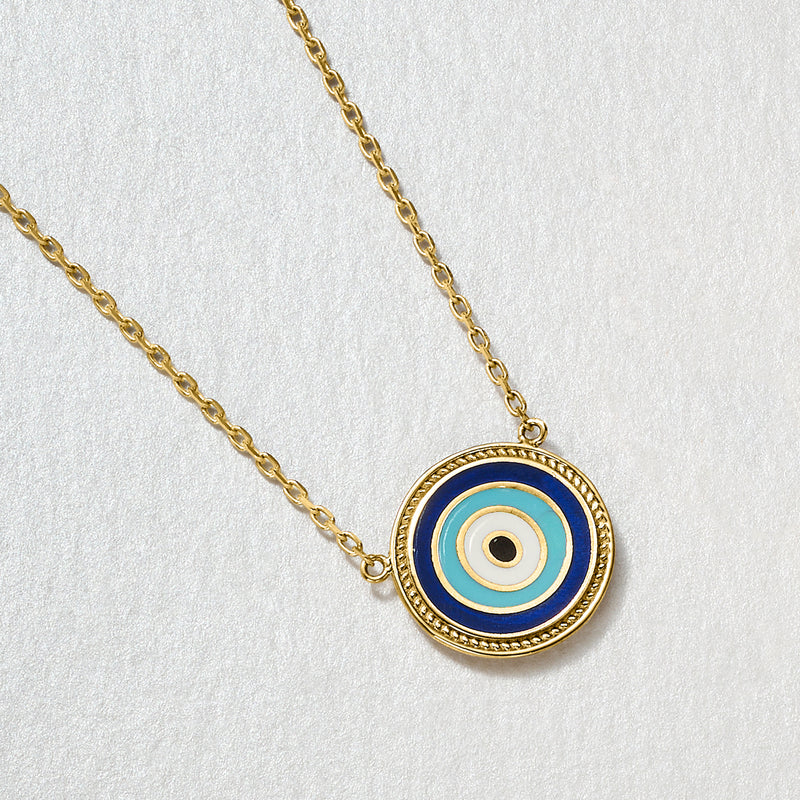 Close-up round evil eye pendant necklace in gold plating with blue enamel