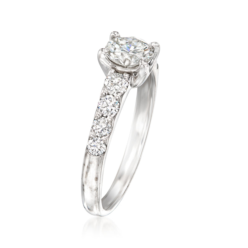 Diamond ring with round center stone and pavé band in 18kt white gold