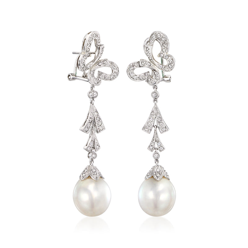 White gold butterfly drop earrings with diamond bow details and cultured pearl dangle