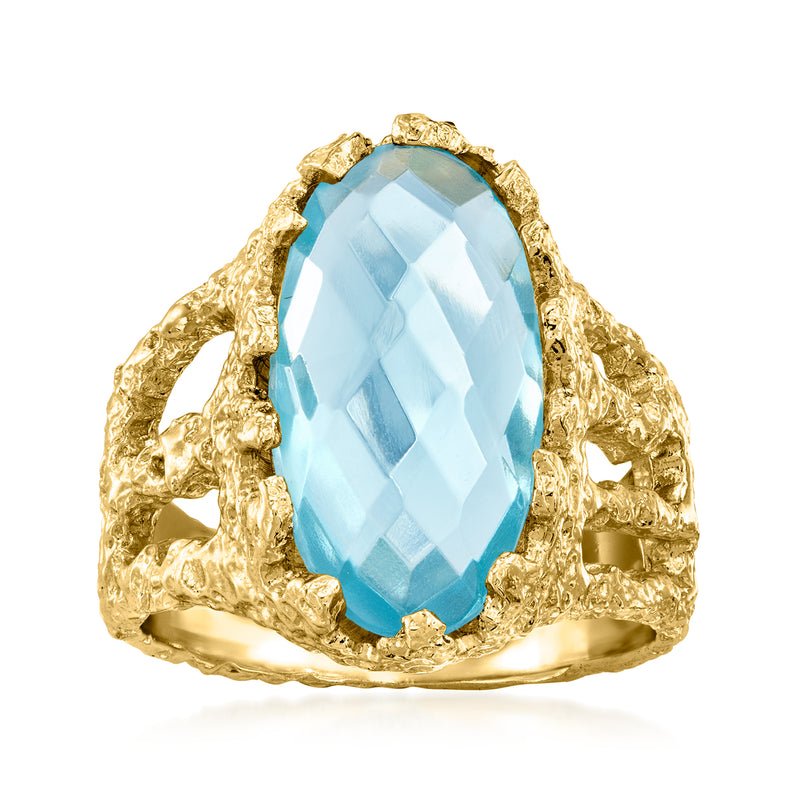 Gold-plated oval ring with simulated blue topaz and ornate textured setting