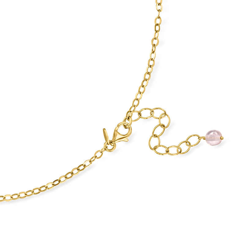 Gold chain with adjustable links and small pink Murano-style bead, necklace end detail