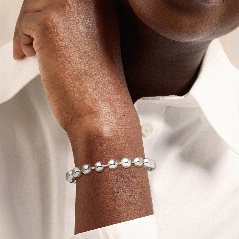 Sterling silver bead bracelet on wrist with round glossy beads and clasp