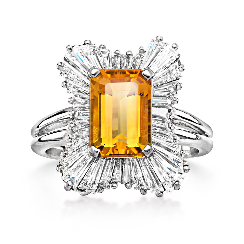 Platinum ring with rectangular orange citrine center and diamond halo prongs