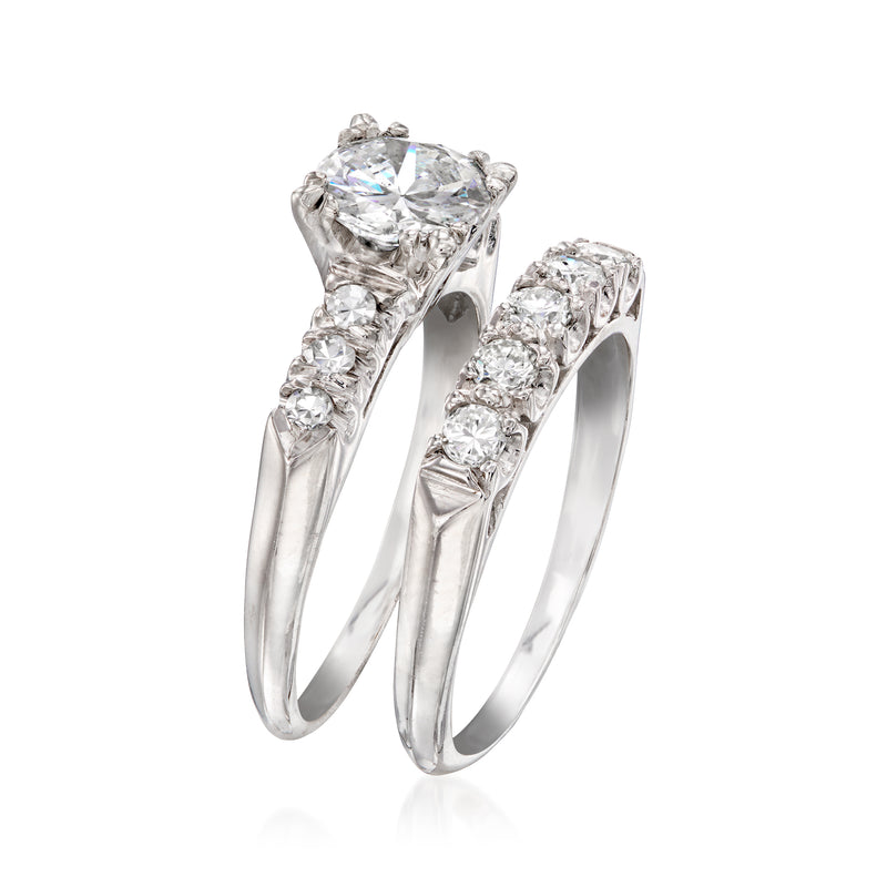 Stacked platinum diamond rings with oval center stones and smaller side diamonds