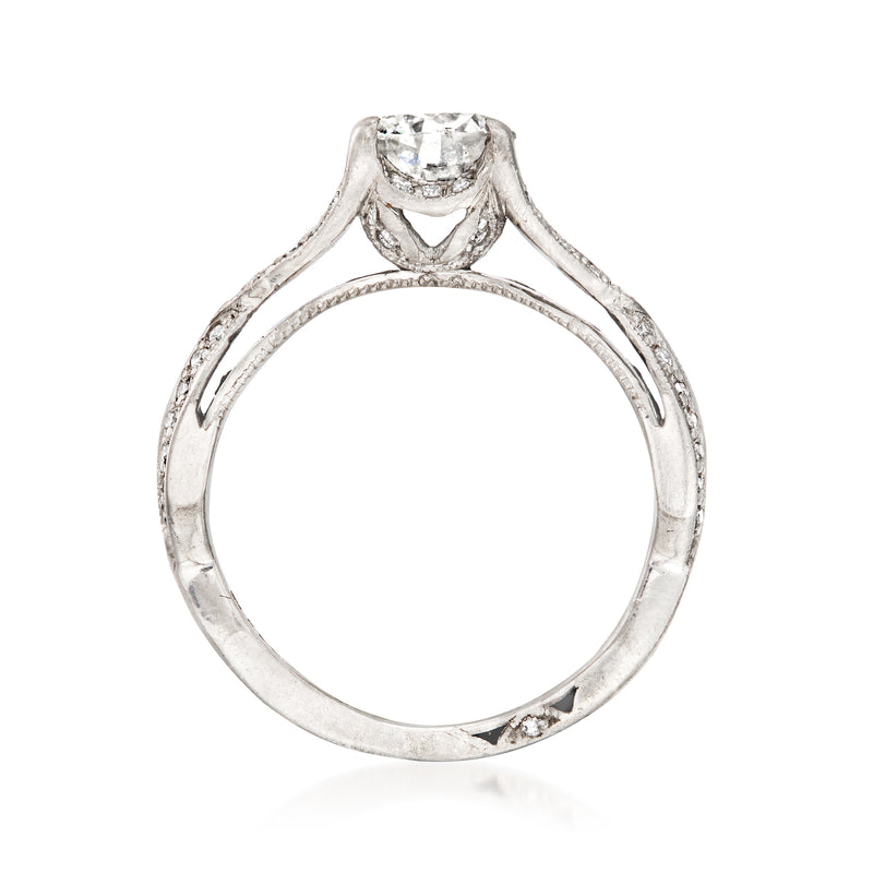 Platinum diamond engagement ring, openwork prongs framing a round center stone