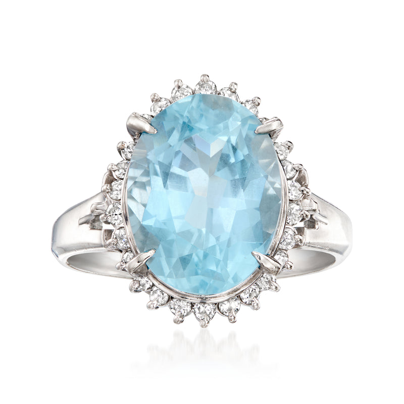 Platinum aquamarine oval ring with diamond halo and side prong details