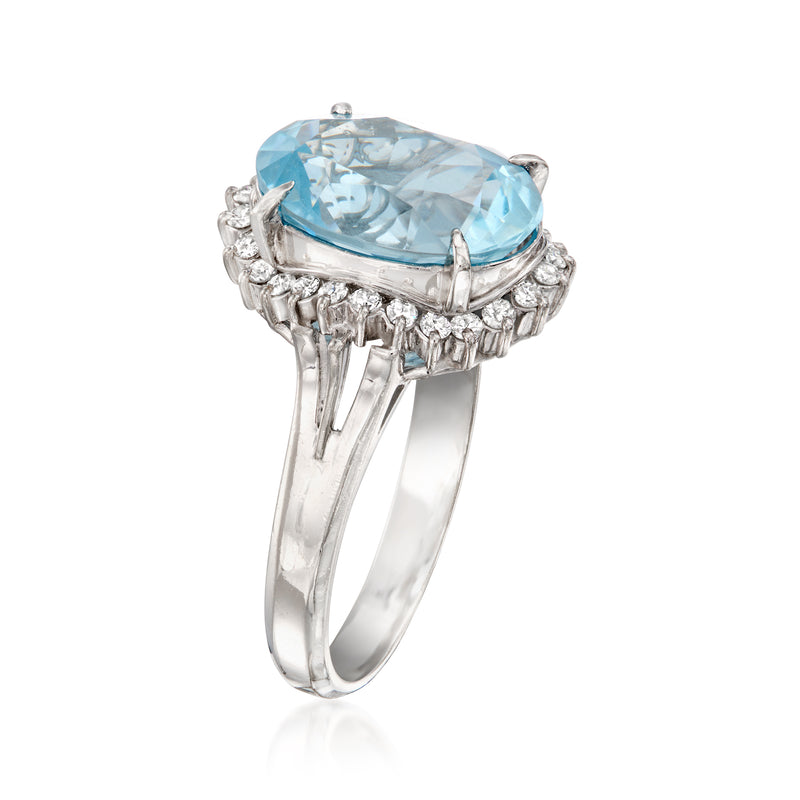 Platinum aquamarine oval ring, raised halo and prong-set diamonds