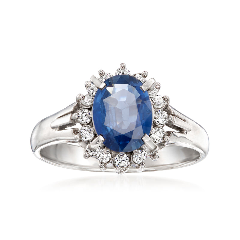 Platinum ring with oval blue sapphire and halo of small diamonds