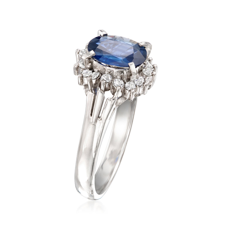 Platinum sapphire ring with large oval blue stone and prong-set diamonds