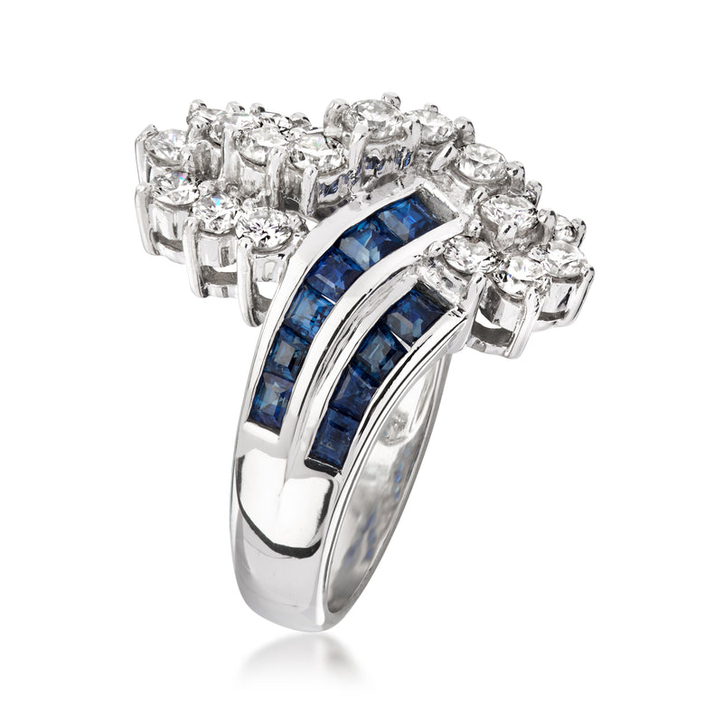 Platinum bypass ring with two blue sapphire inlay bands and surrounding round diamonds