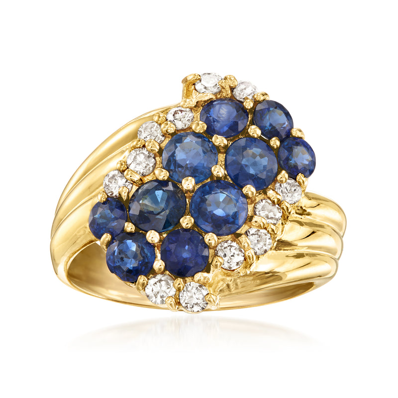 Yellow gold ring with oval blue sapphires and round diamonds in clustered setting