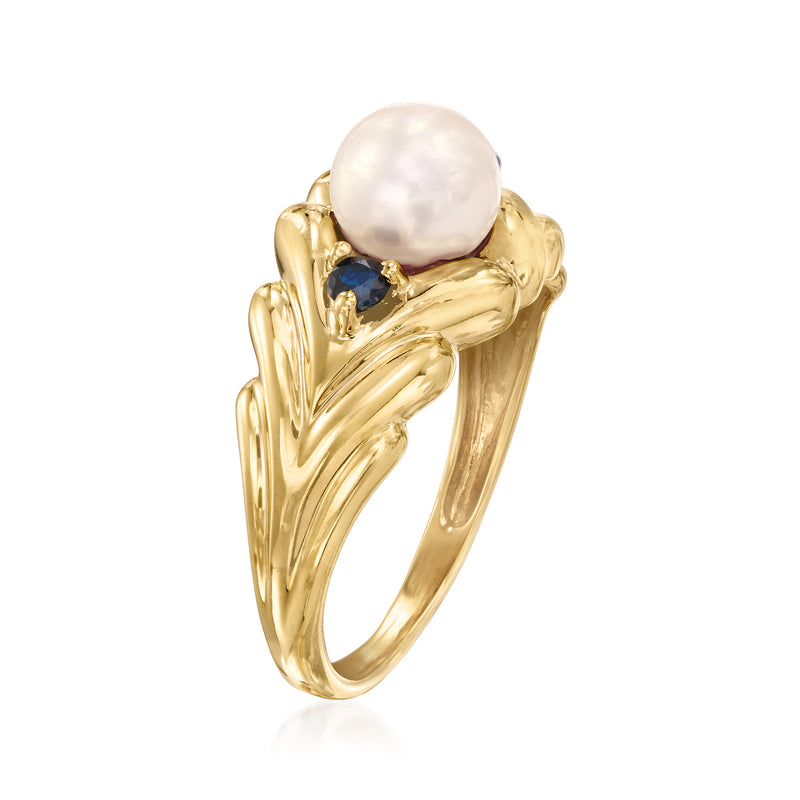 Yellow gold ring with round white pearl center and blue sapphire accents