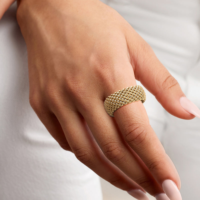 Gold-plated popcorn-chain ring on hand, textured wide band in yellow finish