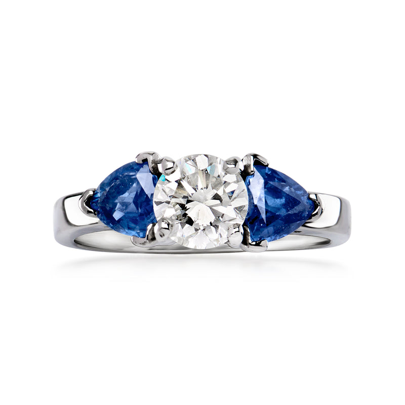 Platinum vintage ring with center round diamond and two blue sapphire side stones