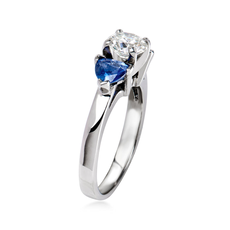 Platinum diamond and sapphire engagement-style ring, angled view