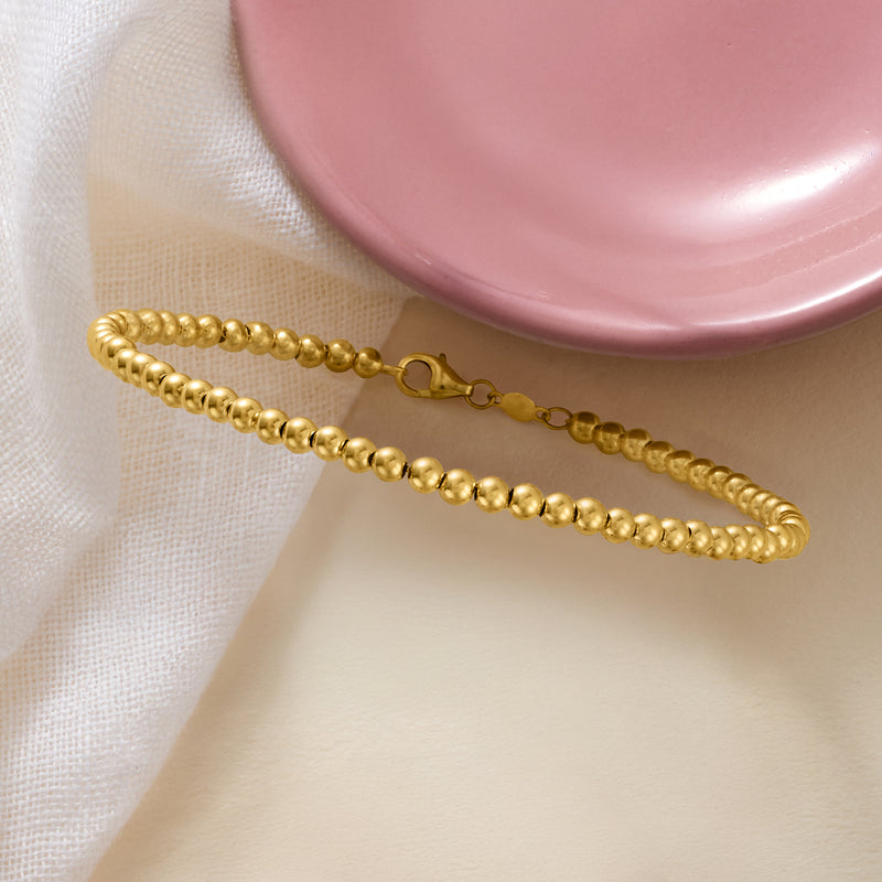 Yellow gold beaded bracelet with toggle clasp detail and round beads
