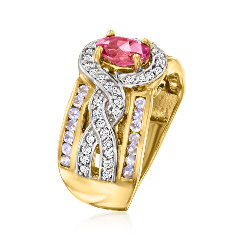 Gold-toned gemstone ring with pink oval center, white stones, and openwork side