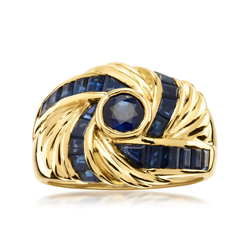 18kt yellow gold swirl ring with blue sapphire and oval center stone