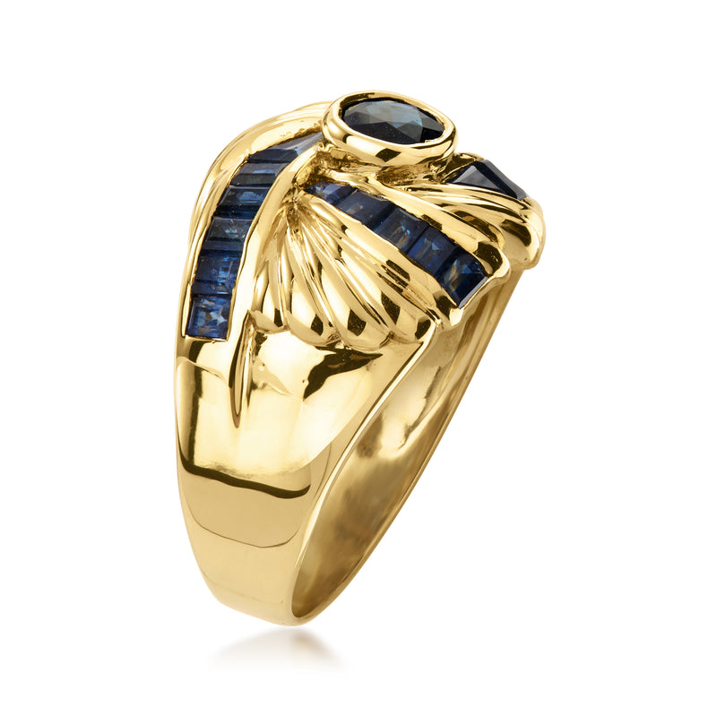 Gold sapphire swirl ring with oval blue center and baguette blue side stones