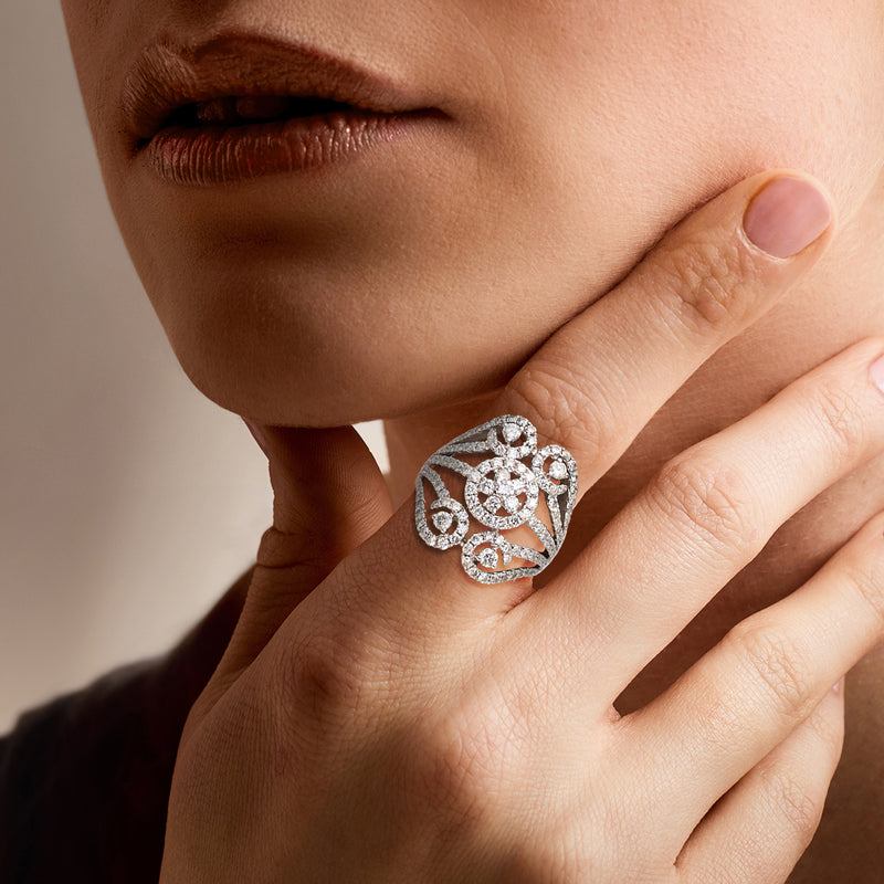 Diamond openwork ring on hand, 18kt white gold with circular center stone halo