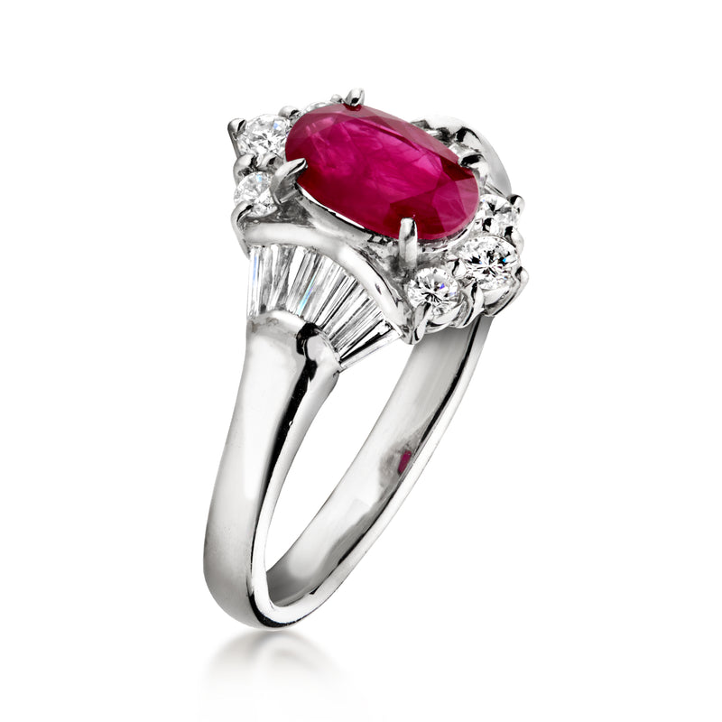 Platinum oval ruby ring with baguette and round diamond side stones, angled view