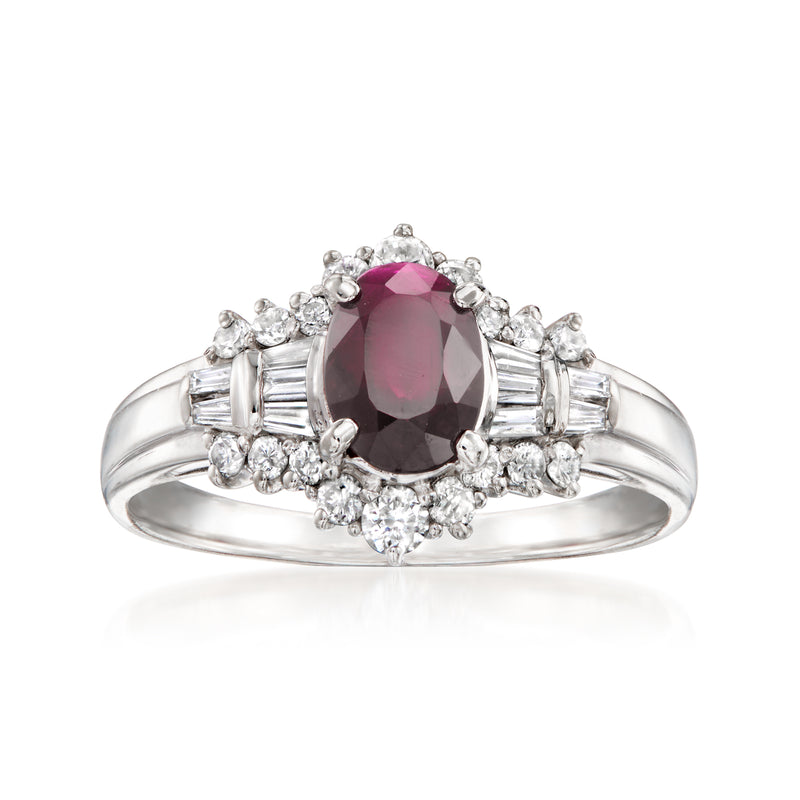 Platinum ruby and diamond ring featuring oval center stone with baguette-set accents