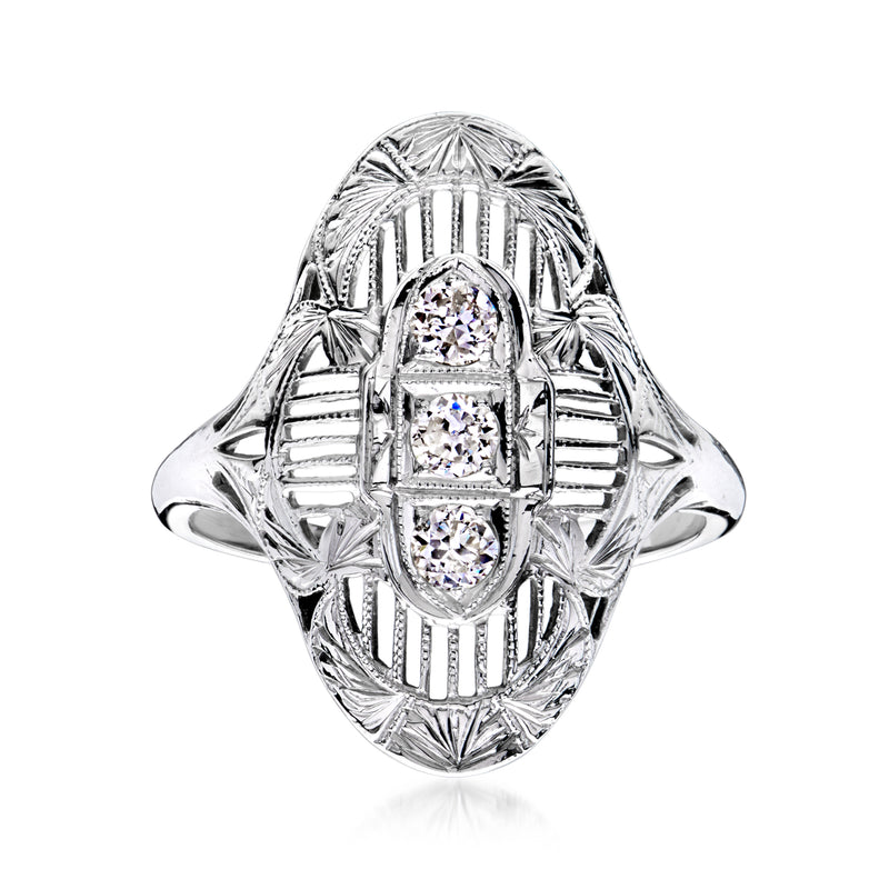 Vintage white gold filigree ring with oval center and three round diamonds