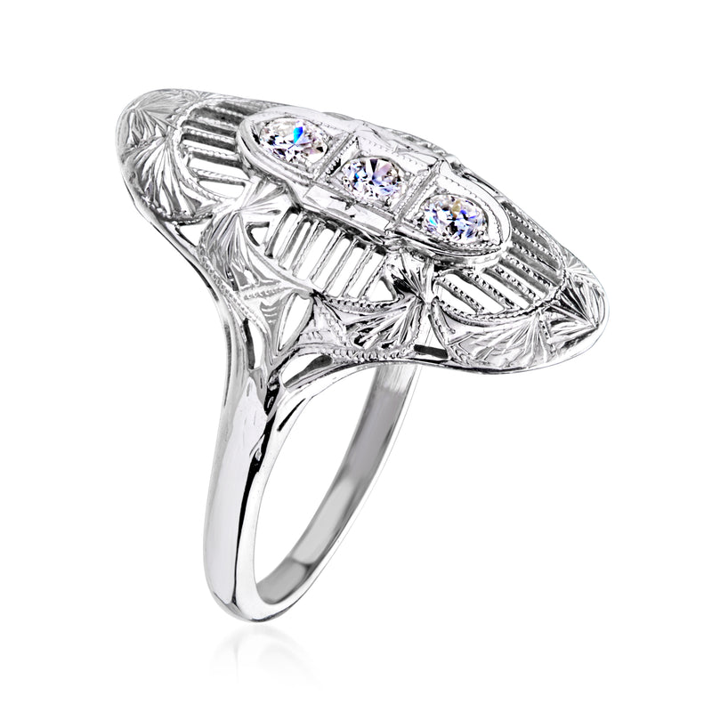 Vintage white gold filigree ring, side view, three round diamonds in oval frame